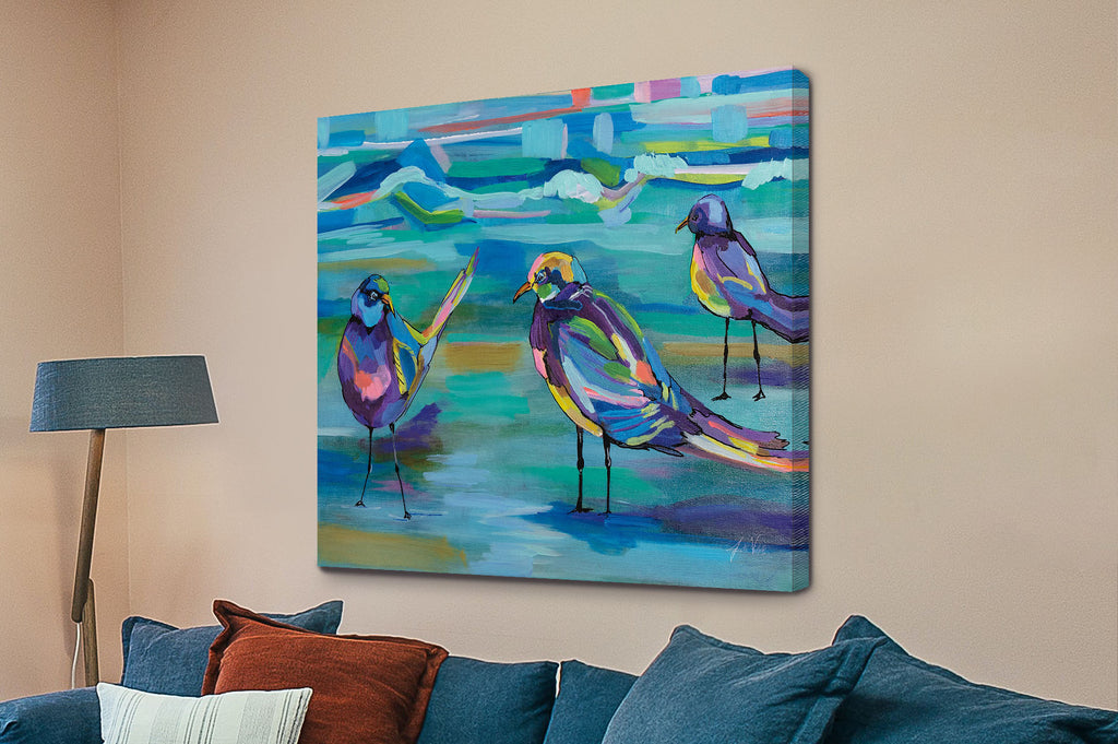 Colorful abstract painting of seagulls on a wall above a sofa, Indigo Gulls by Jeanette Vertentes