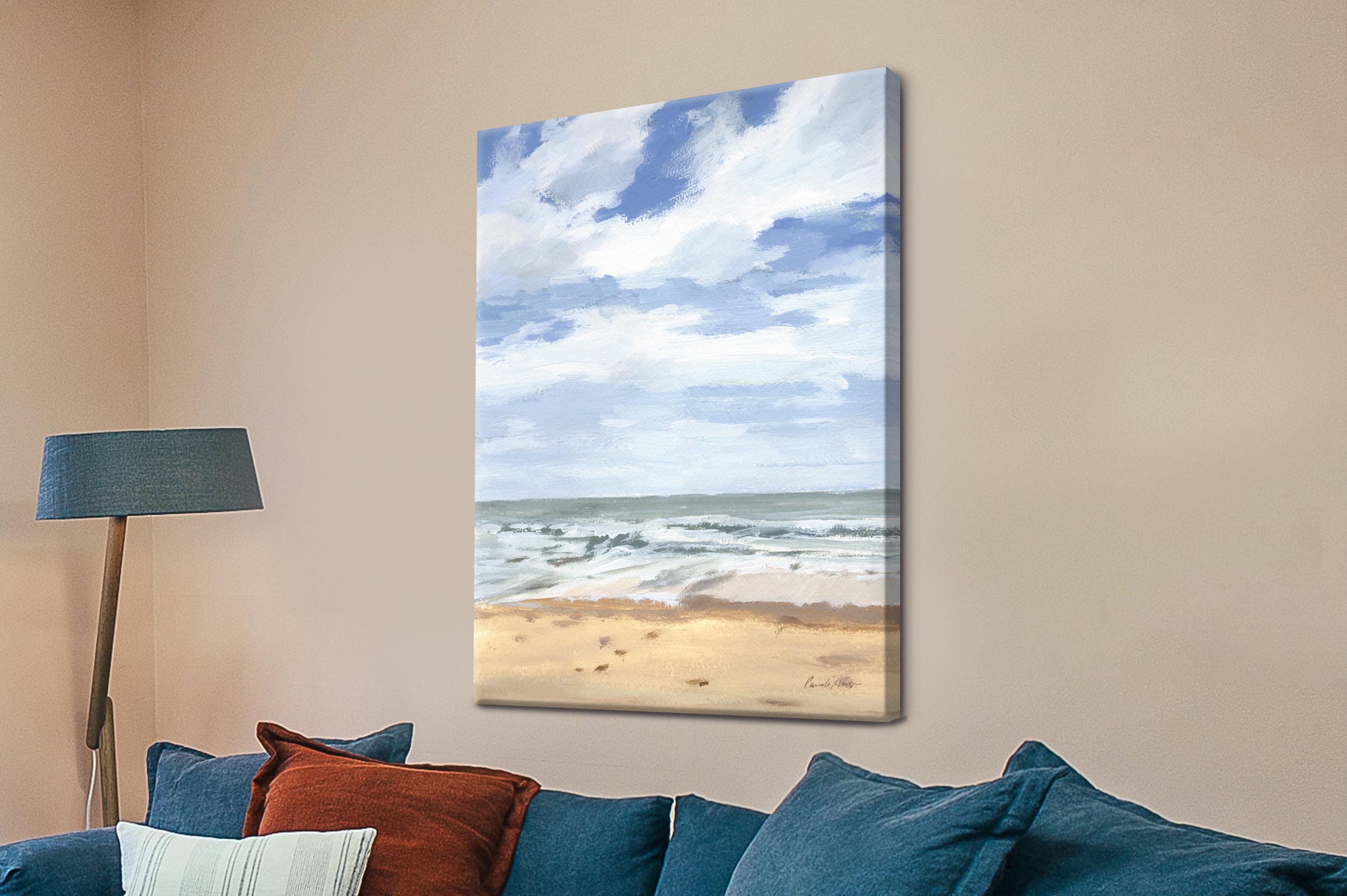 Beach scene painting on a wall above a sofa with colorful cushions.