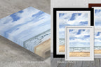 Comparison of stretched canvas prints and framed prints of a beach scene with blue sky.